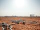 A vast, arid landscape under a scorching sun, the earth parched and cracked. In the foreground, a sprawling network of pipes and valves, the infrastructure struggling to channel the dwindling water supply. Towering desalination plants stand like sentinels on the horizon, their imposing structures a testament to the urgent need for water security. The scene evokes a sense of tension and urgency, a world grappling with the consequences of water scarcity and the critical importance of modernizing water infrastructure to meet the demands of a growing population. The image should convey the essence of the article's subject matter, inviting the viewer to contemplate the challenges and potential solutions surrounding this pressing global issue.