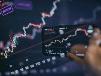 Trader investor broker holding finger using cell phone app executing financial stock trade market trading order to buy or sell
