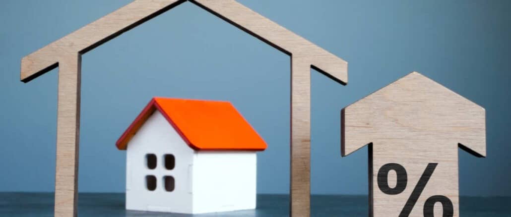 House model, arrow and percent sign as mortgage rates concept.